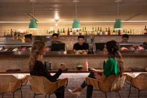 2 ladies sitting at the sushi bar at Hammock Beach Golf Resort & Spa.