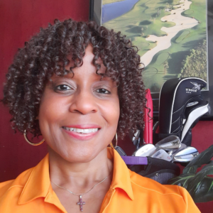 Image of Kristy Edwards with golf clubs behind her