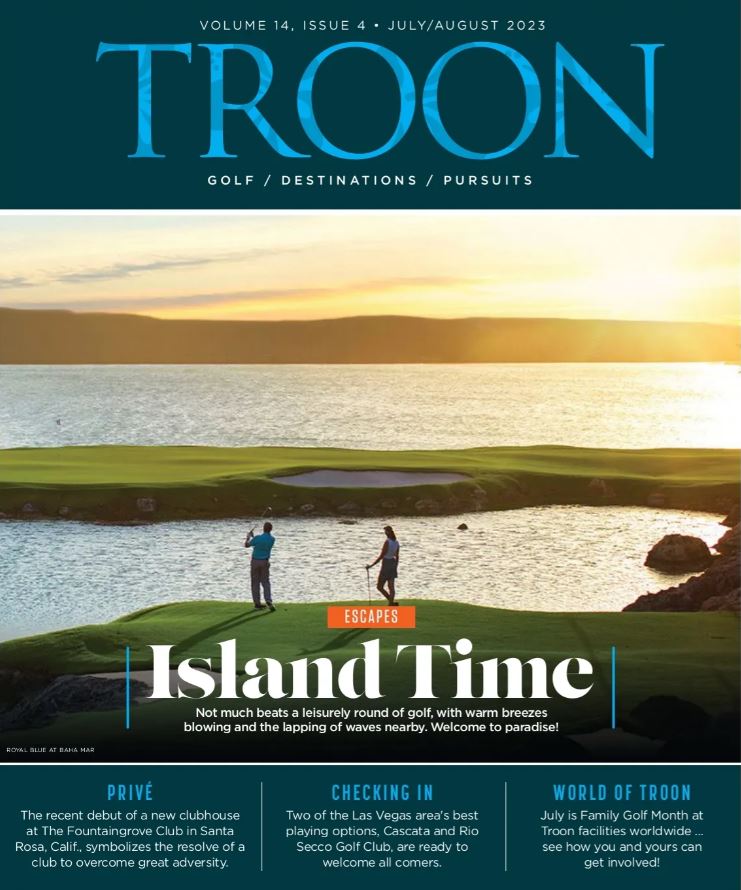 Troon Magazine Cover Volume 14, Issue 4: July/August 2023 - Island Time: Couple teeing off to an island green.